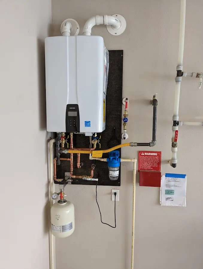 Professional plumber installing copper piping in a Fayette home